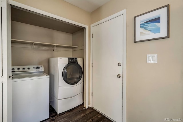 clothes washing area featuring dark hardwood / wood-style flooring and washing machine and clothes dryer