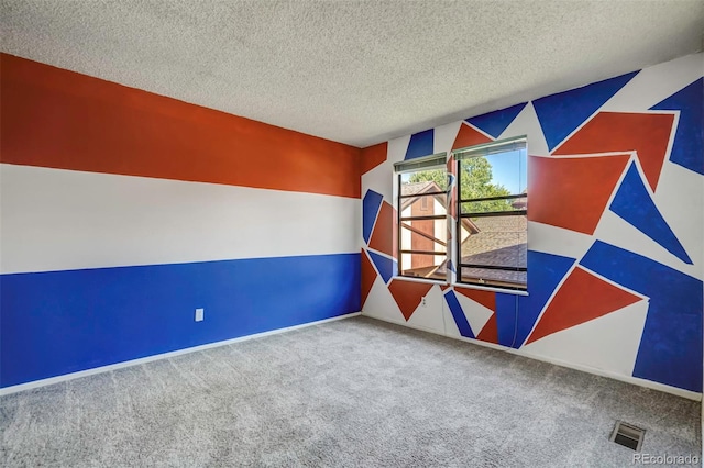 carpeted spare room with a textured ceiling