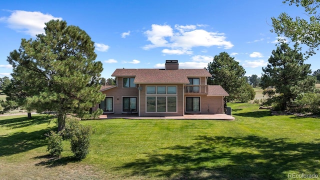 9696 E Sand Lily Ln, Parker, CO 80134 - back of house with a balcony, a lawn, and a patio area