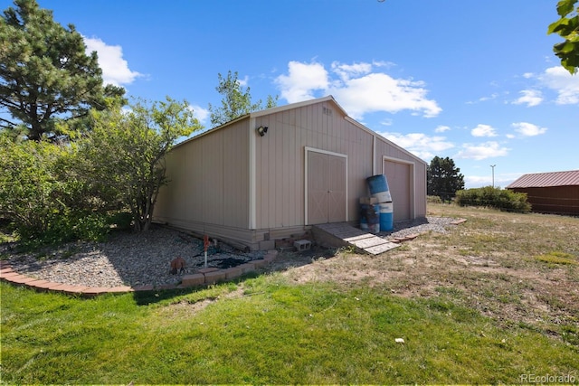 view of outbuilding with a yard