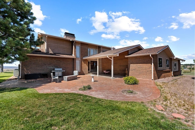 back of house with a lawn and a patio area