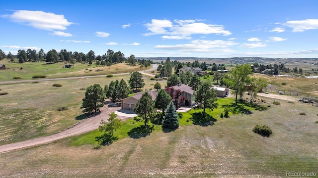 birds eye view of property with a rural view