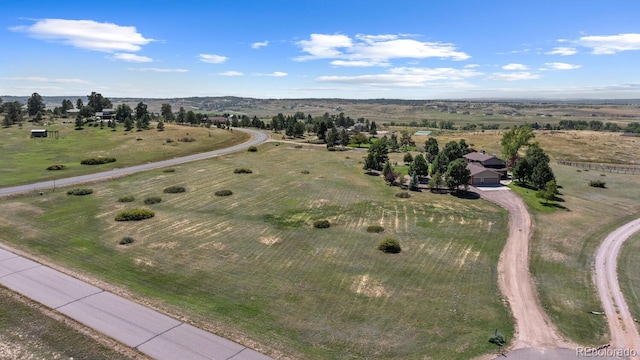 birds eye view of property with a rural view