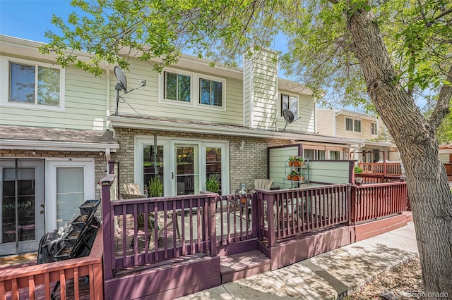 5252 W 68th Ave, Arvada, CO 80003 - back of house with a wooden deck, brick siding, and a chimney