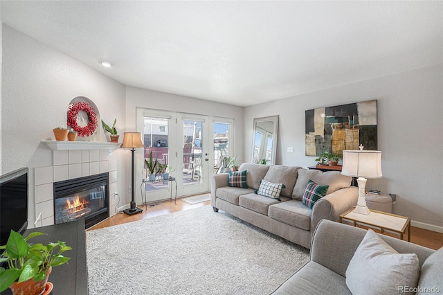 5252 W 68th Ave, Arvada, CO 80003 - living room featuring wood finished floors, a fireplace, and baseboards