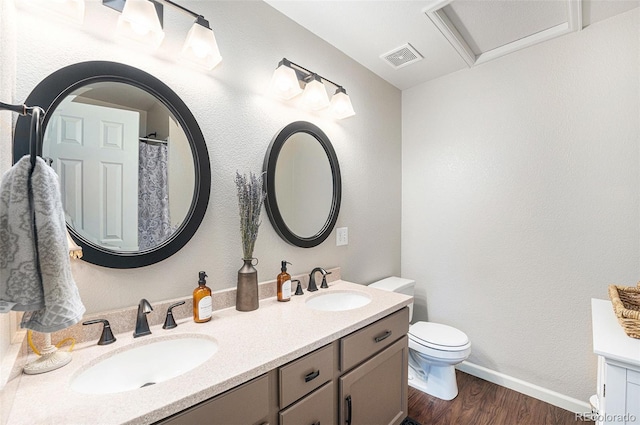 5252 W 68th Ave, Arvada, CO 80003 - full bath with wood finished floors, double vanity, toilet, baseboards, and curtained shower