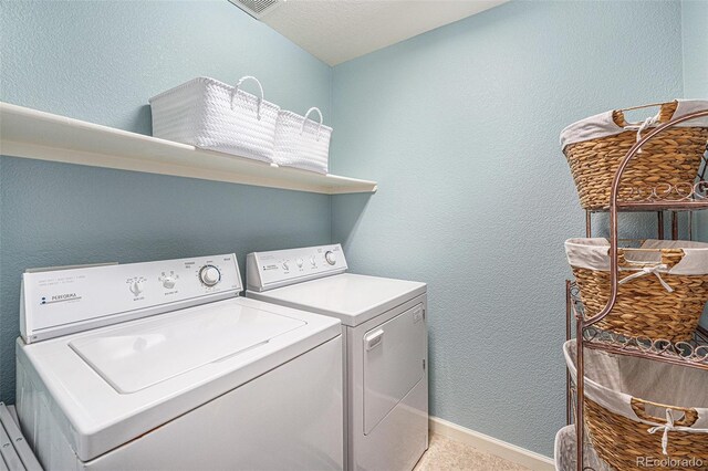 5252 W 68th Ave, Arvada, CO 80003 - washroom featuring washing machine and dryer, baseboards, and a textured wall