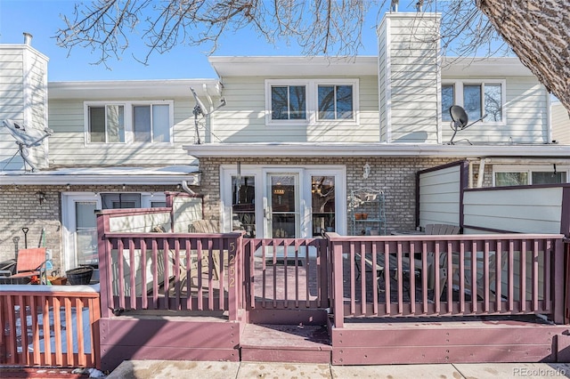5252 W 68th Ave, Arvada, CO 80003 - view of front of house featuring a chimney, brick siding, and a wooden deck