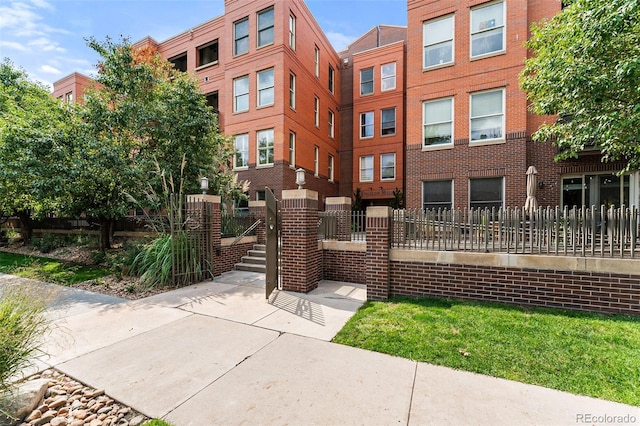 view of building exterior with a fenced front yard