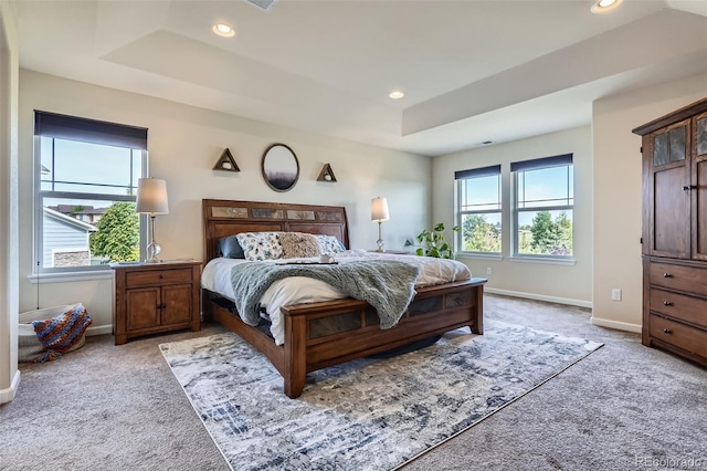 7485 S Jackson Gap Way, Aurora, CO 80016 - bedroom with light colored carpet, a tray ceiling, multiple windows, and recessed lighting