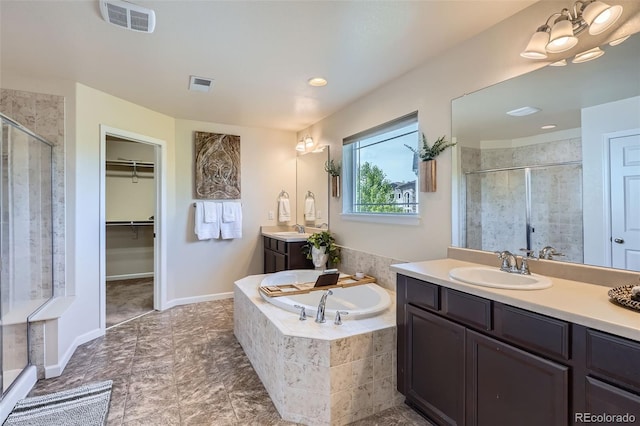 7485 S Jackson Gap Way, Aurora, CO 80016 - full bath with a stall shower, two vanities, a garden tub, and a walk in closet