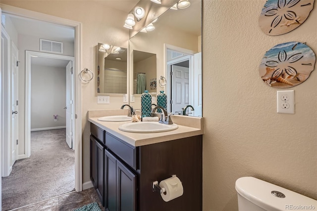 7485 S Jackson Gap Way, Aurora, CO 80016 - bathroom featuring double vanity, toilet, and baseboards