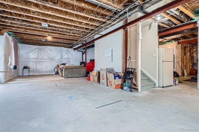 7485 S Jackson Gap Way, Aurora, CO 80016 - unfinished below grade area featuring freestanding refrigerator and stairs