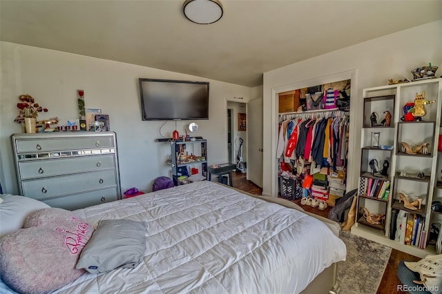 bedroom featuring vaulted ceiling, a closet, and wood finished floors