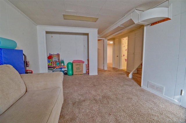 interior space featuring stairs, visible vents, carpet flooring, and ornamental molding