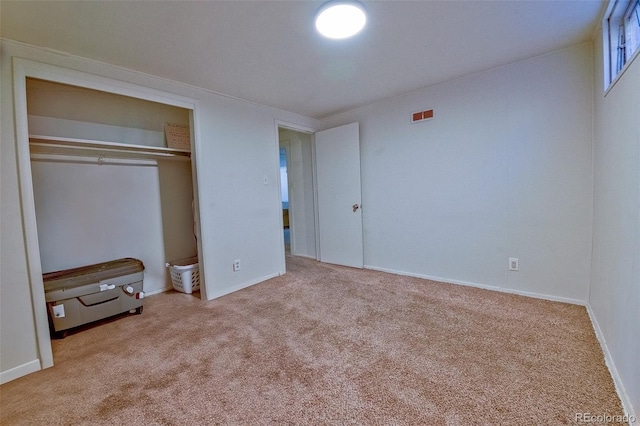 unfurnished bedroom featuring baseboards, carpet, visible vents, and a closet