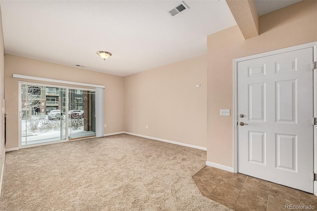 carpeted spare room featuring beam ceiling