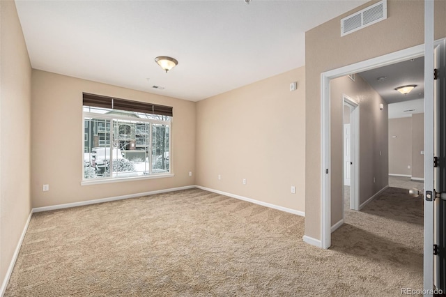 spare room with light colored carpet