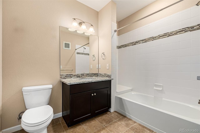 full bathroom with toilet, vanity, and tiled shower / bath