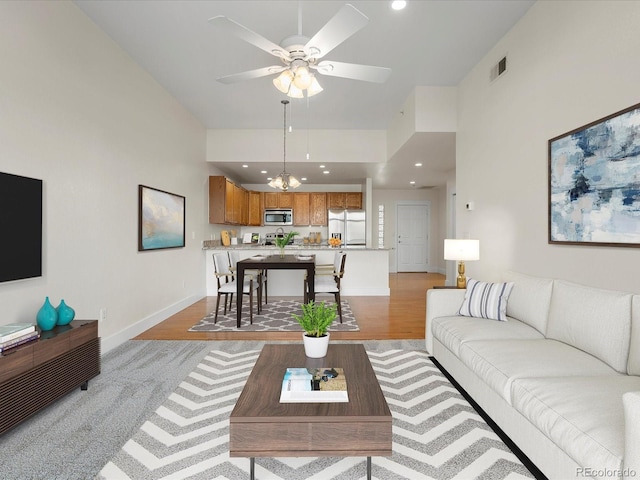 living area featuring visible vents, recessed lighting, light wood-style floors, and baseboards