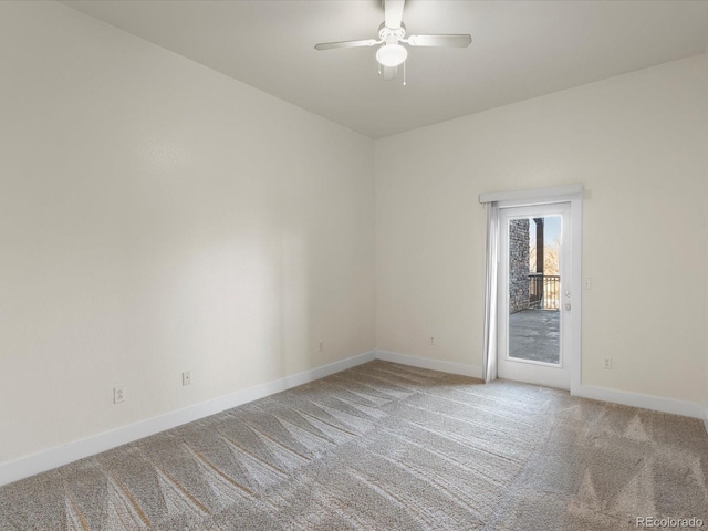 carpeted empty room with baseboards and a ceiling fan