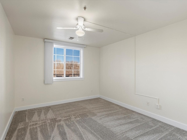 carpeted empty room with visible vents, ceiling fan, and baseboards