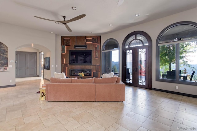 28154 Belle Mont Trl, Conifer, CO 80433 - living area featuring arched walkways, ceiling fan, baseboards, recessed lighting, and a large fireplace