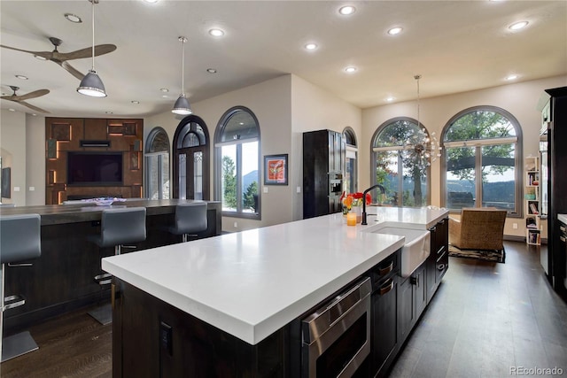 28154 Belle Mont Trl, Conifer, CO 80433 - kitchen featuring a sink, stainless steel microwave, recessed lighting, dark wood-style flooring, and open floor plan