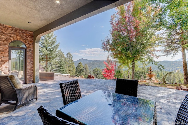 28154 Belle Mont Trl, Conifer, CO 80433 - view of patio featuring a mountain view and outdoor dining space
