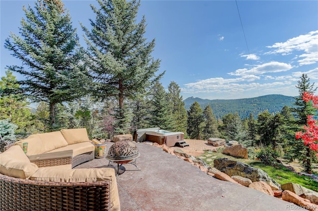 28154 Belle Mont Trl, Conifer, CO 80433 - view of patio with outdoor lounge area, a mountain view, and a view of trees