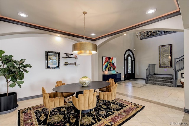 28154 Belle Mont Trl, Conifer, CO 80433 - dining room with stairway, arched walkways, light tile patterned flooring, inlaid floor details, and baseboards