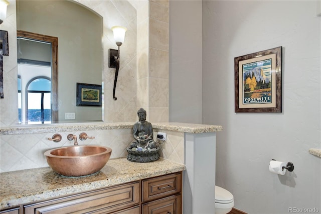 28154 Belle Mont Trl, Conifer, CO 80433 - bathroom featuring decorative backsplash, toilet, and vanity