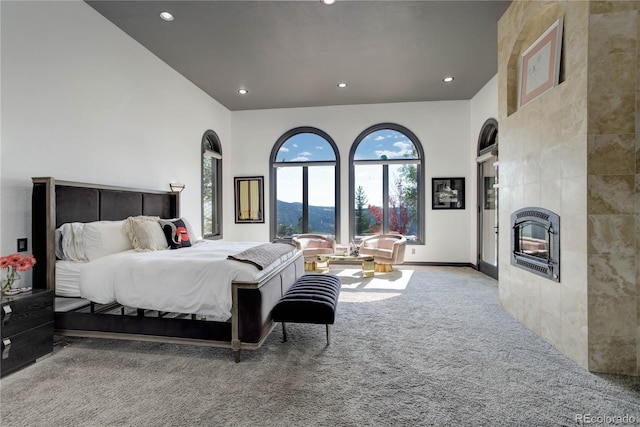 28154 Belle Mont Trl, Conifer, CO 80433 - carpeted bedroom featuring multiple windows, recessed lighting, a tile fireplace, and baseboards