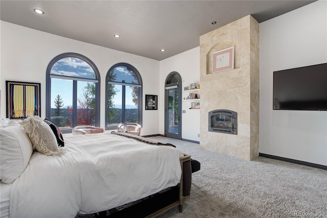 28154 Belle Mont Trl, Conifer, CO 80433 - carpeted bedroom with baseboards, heating unit, recessed lighting, a tile fireplace, and access to outside