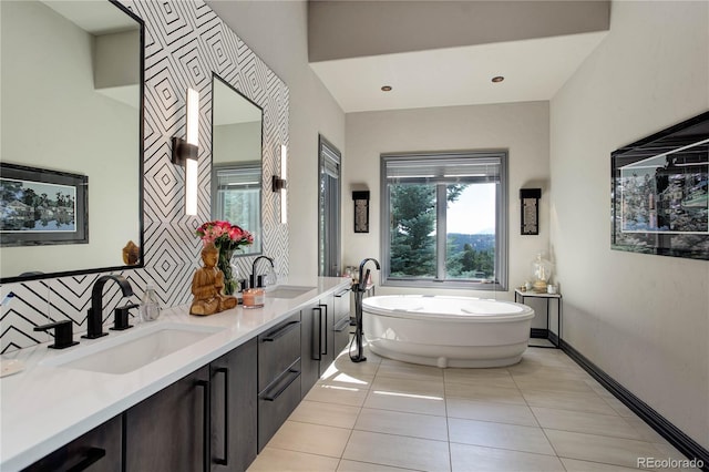 28154 Belle Mont Trl, Conifer, CO 80433 - full bathroom featuring a freestanding bath, tile patterned flooring, double vanity, and baseboards