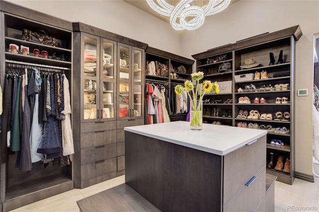 28154 Belle Mont Trl, Conifer, CO 80433 - walk in closet featuring light tile patterned floors and a chandelier