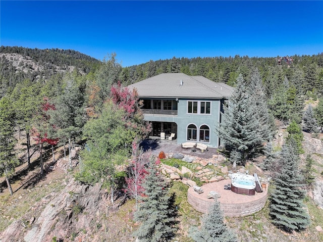 28154 Belle Mont Trl, Conifer, CO 80433 - rear view of house featuring a wooded view, a balcony, and a patio