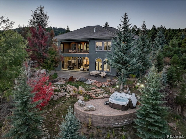 28154 Belle Mont Trl, Conifer, CO 80433 - rear view of house with a patio, a balcony, and stucco siding