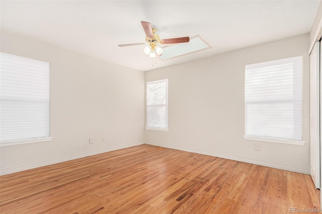 unfurnished room featuring ceiling fan, plenty of natural light, and light wood-type flooring