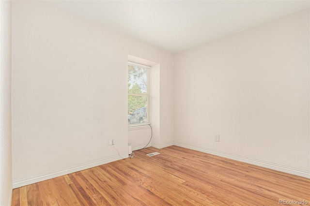 spare room featuring light hardwood / wood-style floors