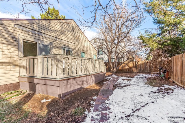 snow covered property featuring a deck