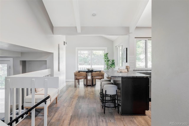 4821 W 102nd Ave, Westminster, CO 80031 - kitchen featuring light wood-style flooring, light stone countertops, a breakfast bar, and healthy amount of natural light