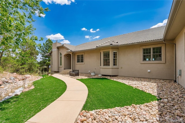 back of house featuring a lawn