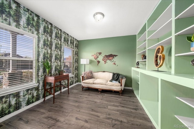 living area with baseboards and wood finished floors