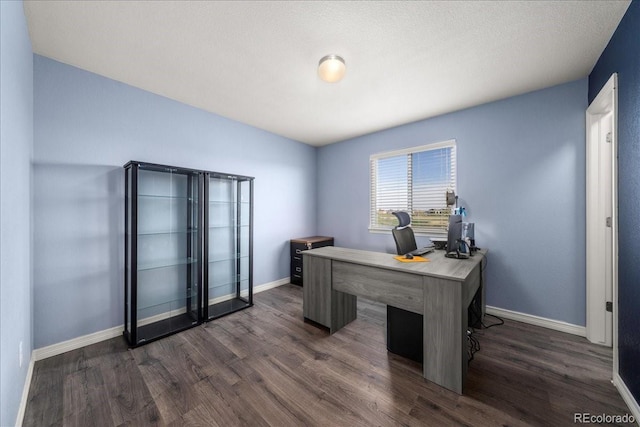 office area featuring baseboards and dark wood finished floors