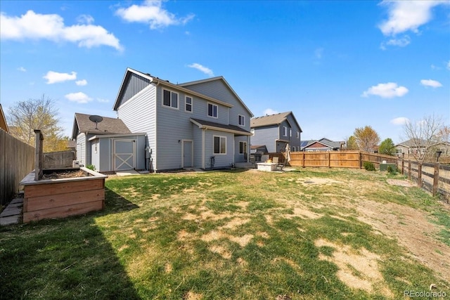 rear view of house with an outdoor structure, a fenced backyard, board and batten siding, a storage shed, and a yard