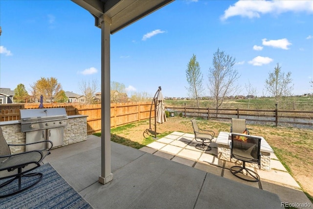 view of patio / terrace featuring an outdoor kitchen, grilling area, and a fenced backyard