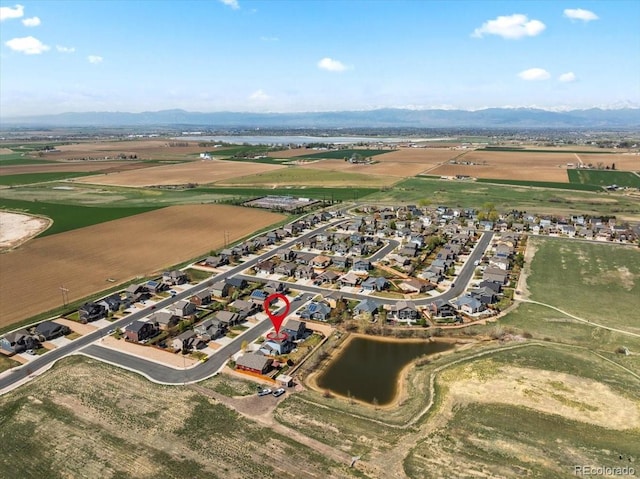 drone / aerial view featuring a residential view and a water and mountain view