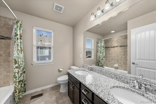 bathroom featuring a sink, baseboards, toilet, and visible vents