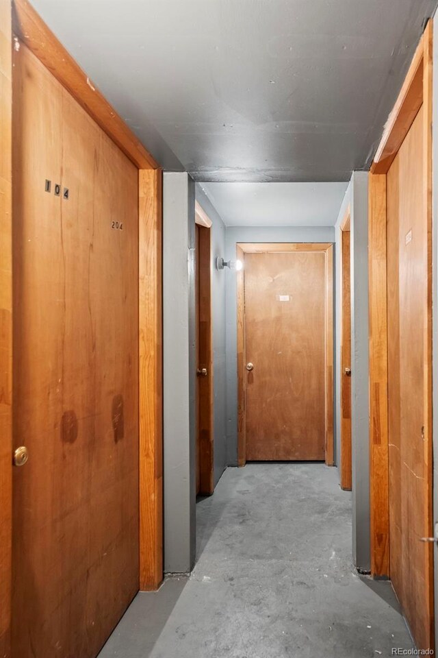 hall featuring unfinished concrete floors